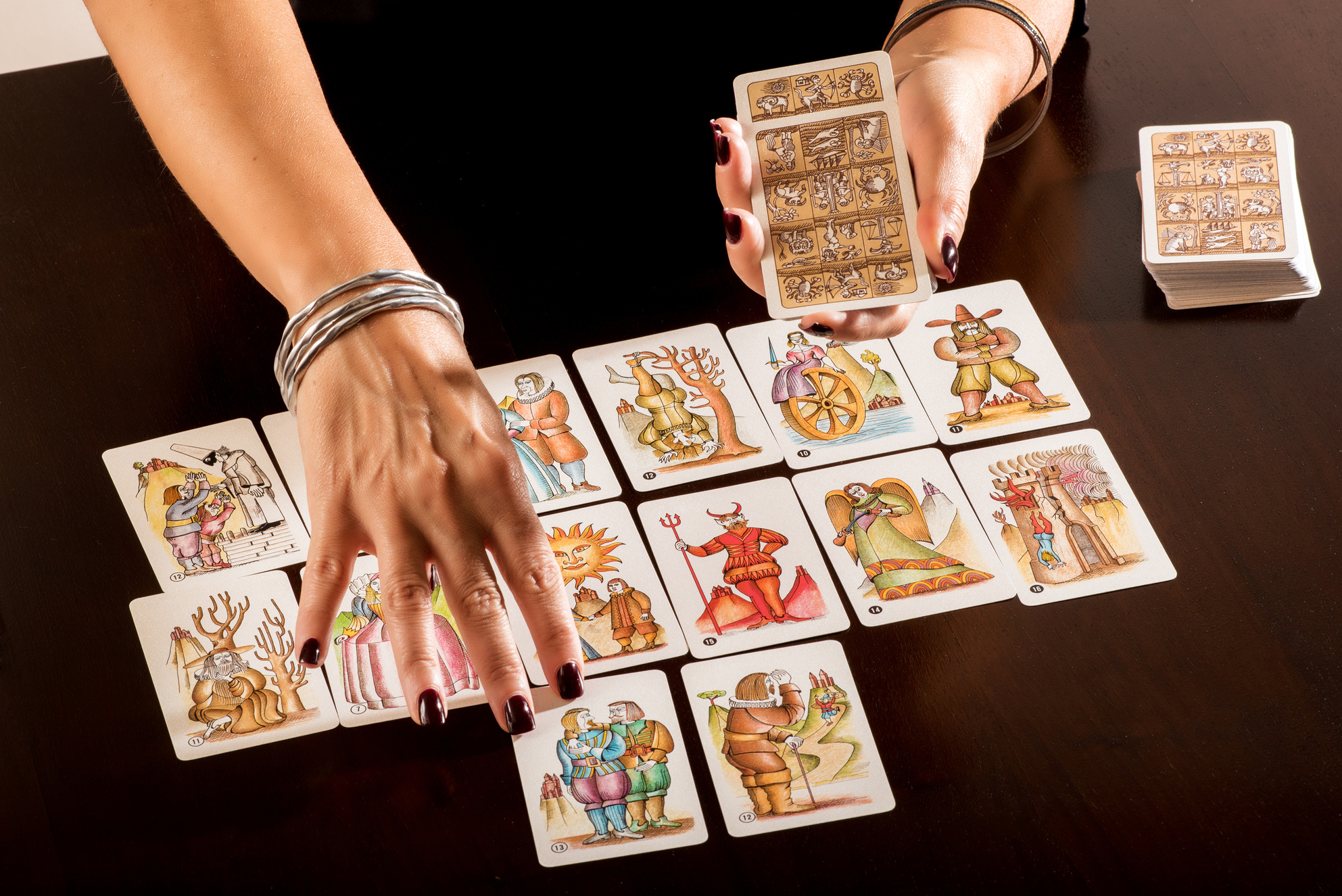 Fortune Teller Laying Out a Deck of Tarot Cards